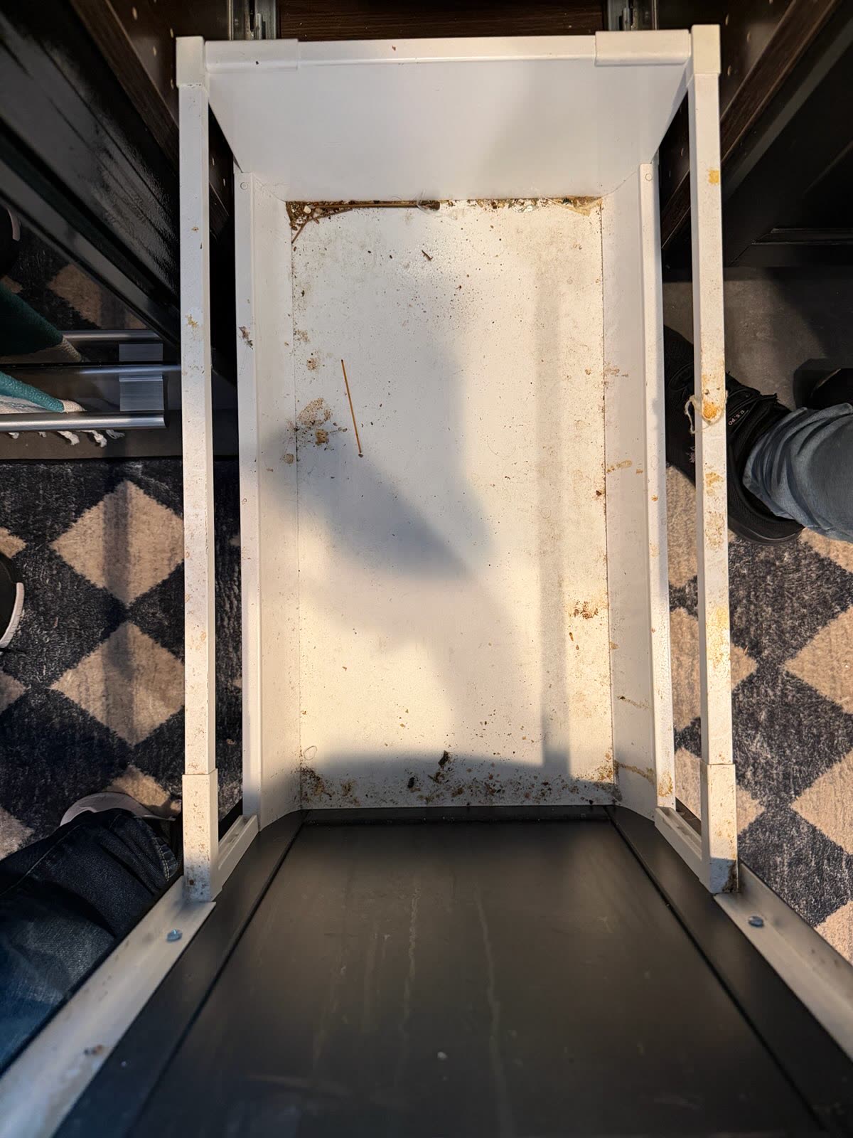 Stained pull-out refrigerator drawer before cleaning
