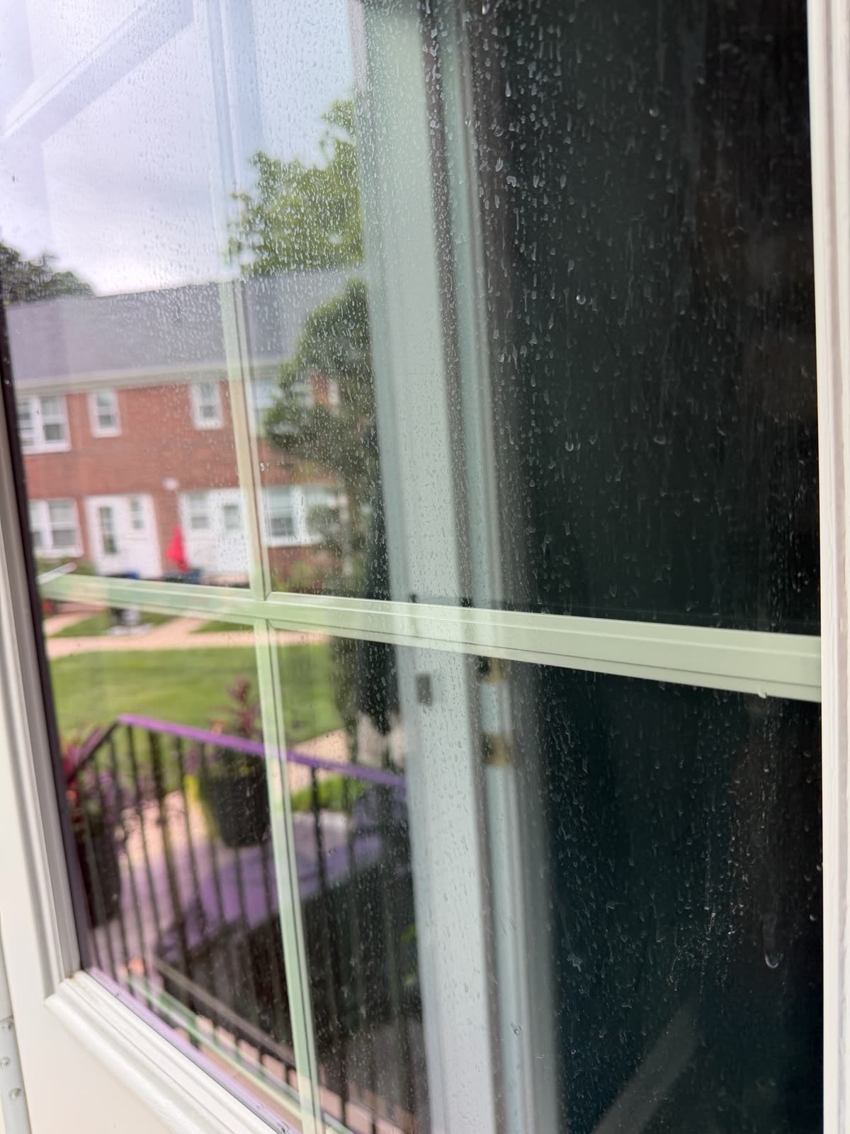Window glass covered in spots and grime before cleaning